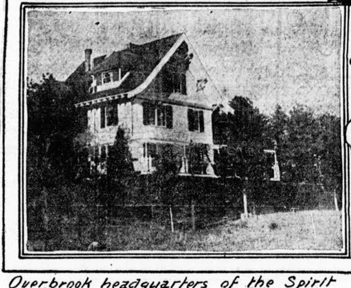 Halftone photograph of a large gabled house with a dormer and open columned porch behind a fenced field, captioned 'Overbrook headquarters of the Spirit Fruit Cult'